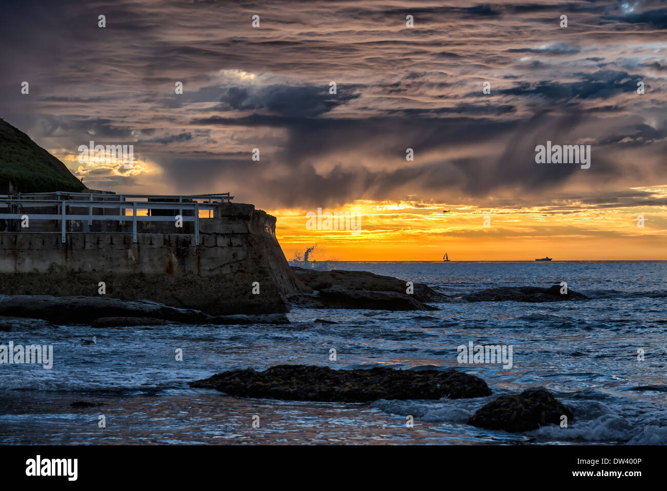 Beach and seawall during sunset. San Diego, California, United States
