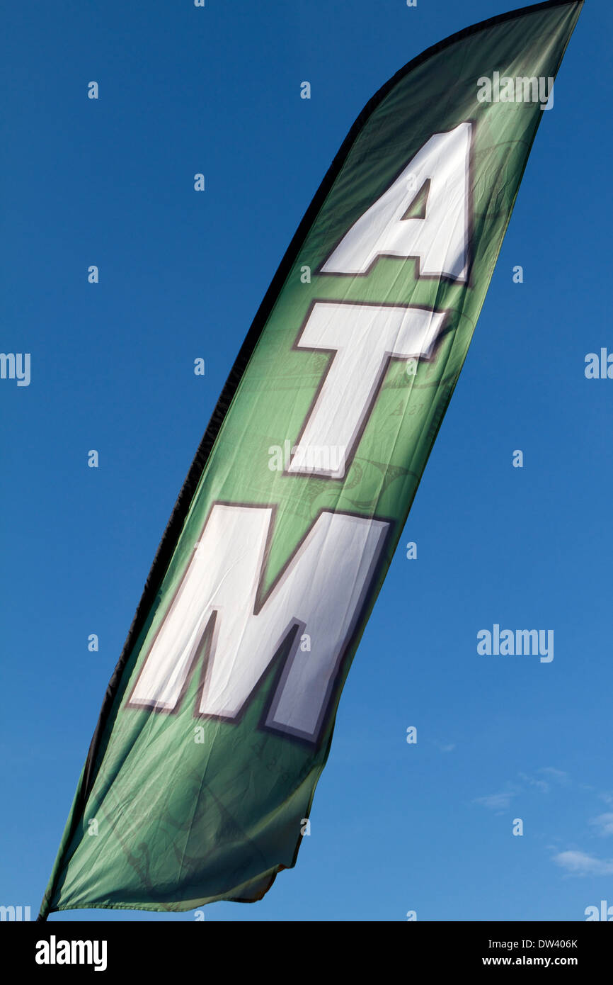 ATM sign flag at an outdoor event directing visitors to a cash credit ...