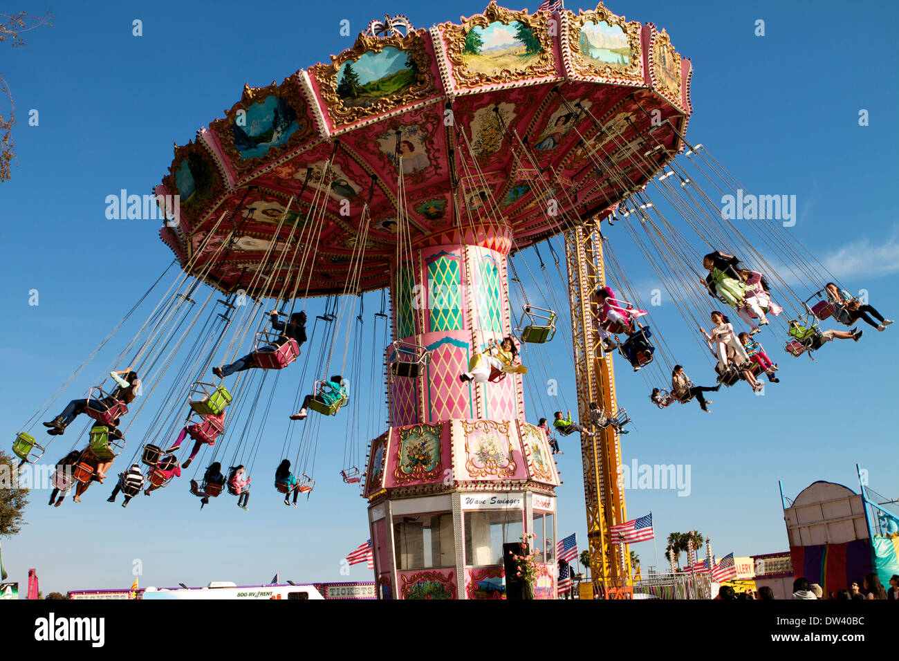 Young Children ride on the wave swing at the Orange County fair grounds during the Vietnamese Tet Festival Stock Photo