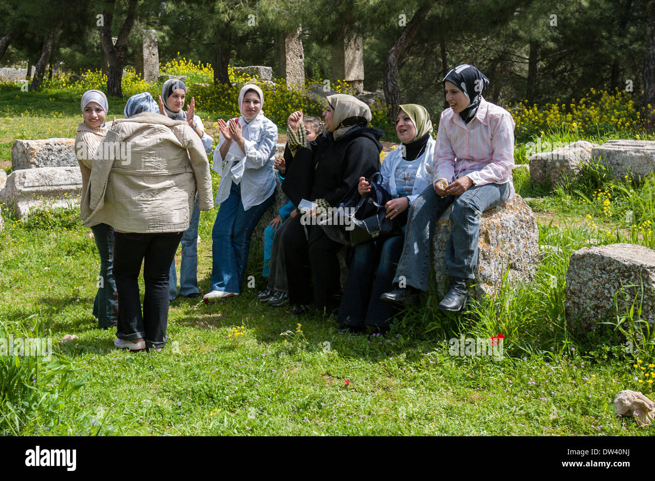 Group of Muslim women singing and clapping hands at the Basilica of St. Simeon near Aleppo, Syria. Stock Photo