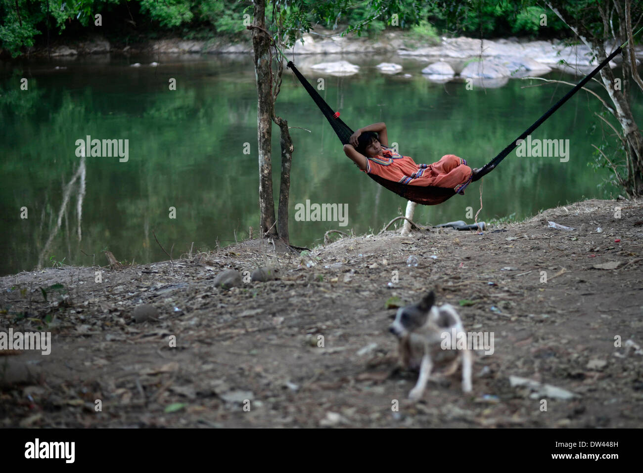 (140227) -- NGABE BUGLE REGION, Feb. 27, 2014 (Xinhua) -- A woman of the Ngabe Bugle ethnic group rests in a camp near the Tabasara river bank in the Ngabe Bugle indigenous region, 450 km west of Panama City, capital of Panama, on Feb. 24, 2014. The Ngabe Bugle indigenous region is located in the western region of Panama, and covers an area of 6,968 square km, with 91 per cent of its population living in extreme poverty. Native leaders of the Ngabe Bugle region declared a 'national alert', because of the eviction notice issued by a company which is developing the hydro-electric project 'Barro Stock Photo