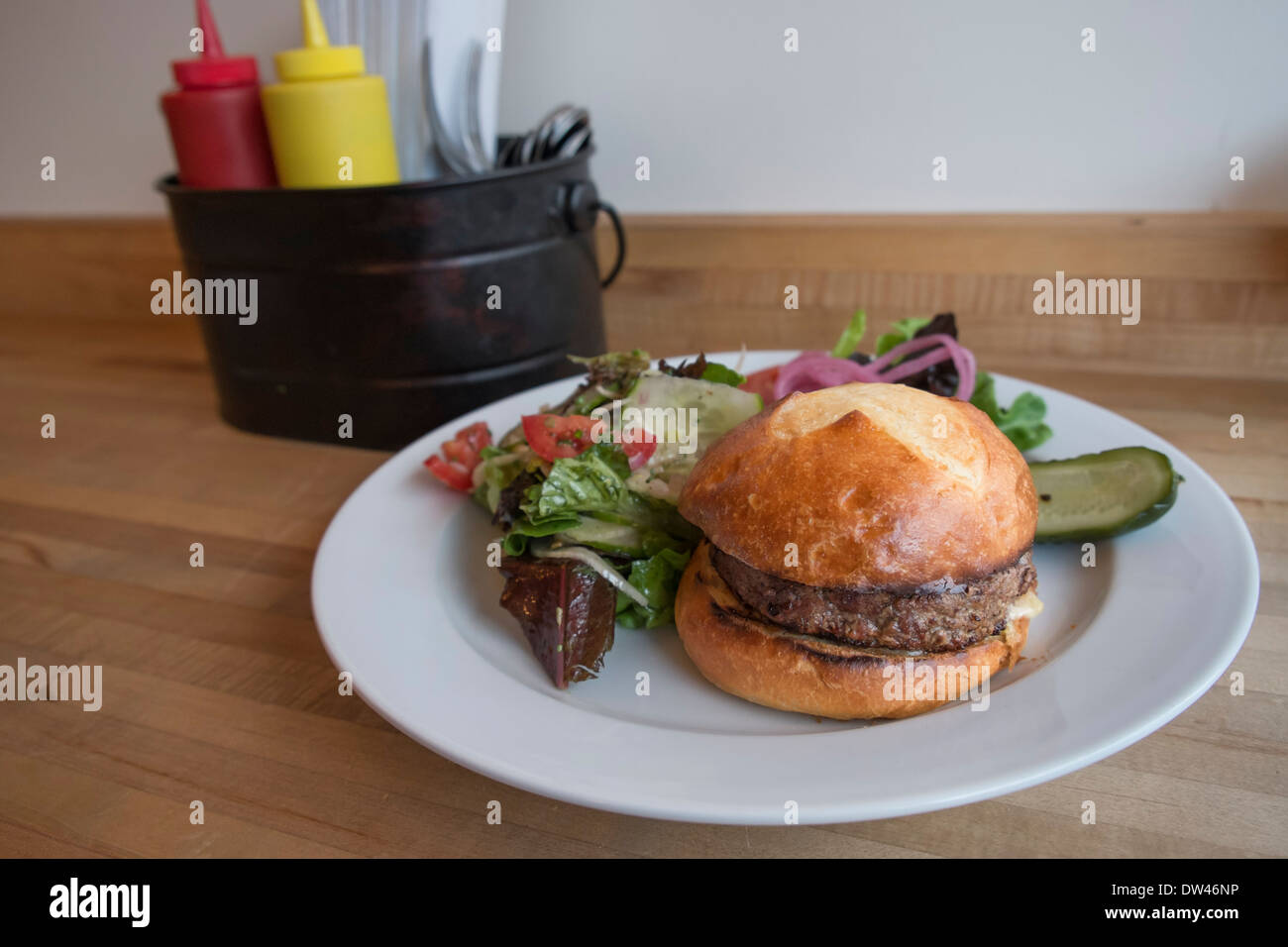 Hamburger sandwich and salad served on a plate Stock Photo