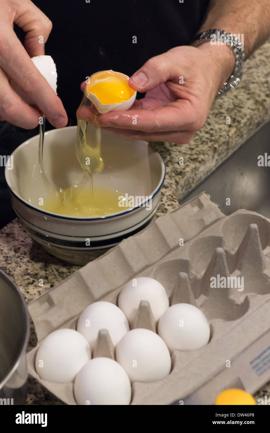 Separating egg white from yolk Stock Photo