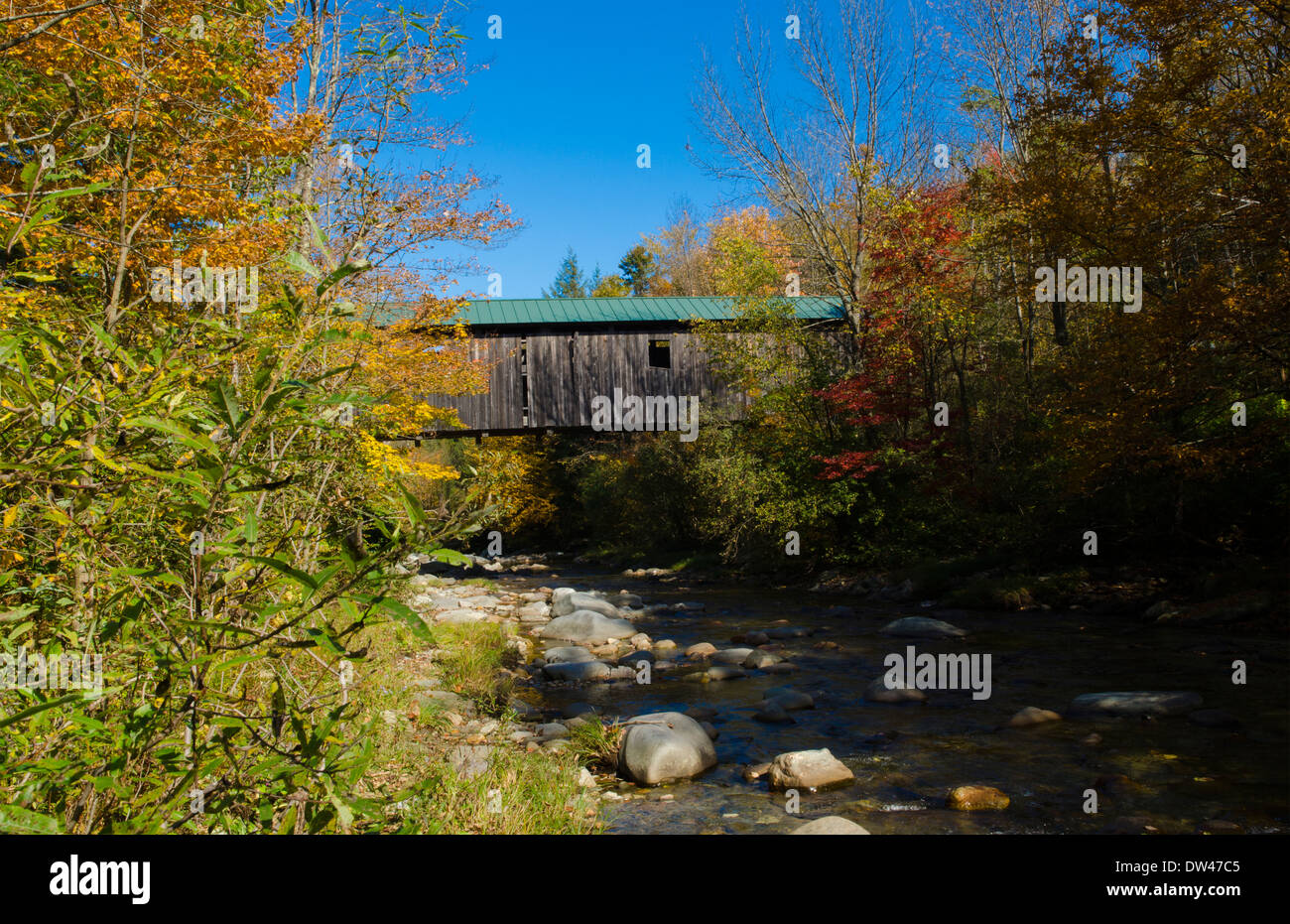 Jeffersonville Vermont covered bridge Grist Mill Covered Bridge over river with fall foliage in
