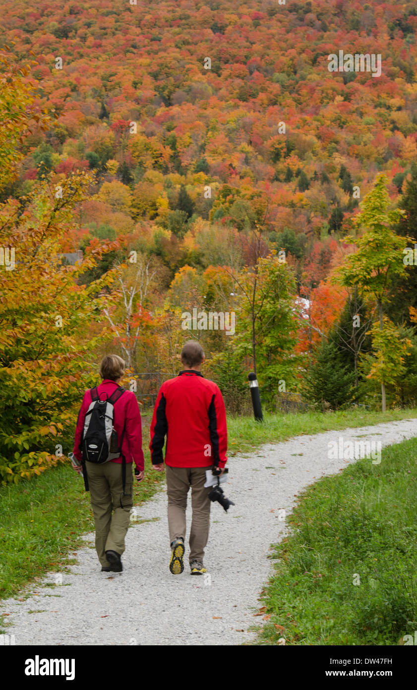 Littleton New Hampshire fall foliage colors tourist couple walking on