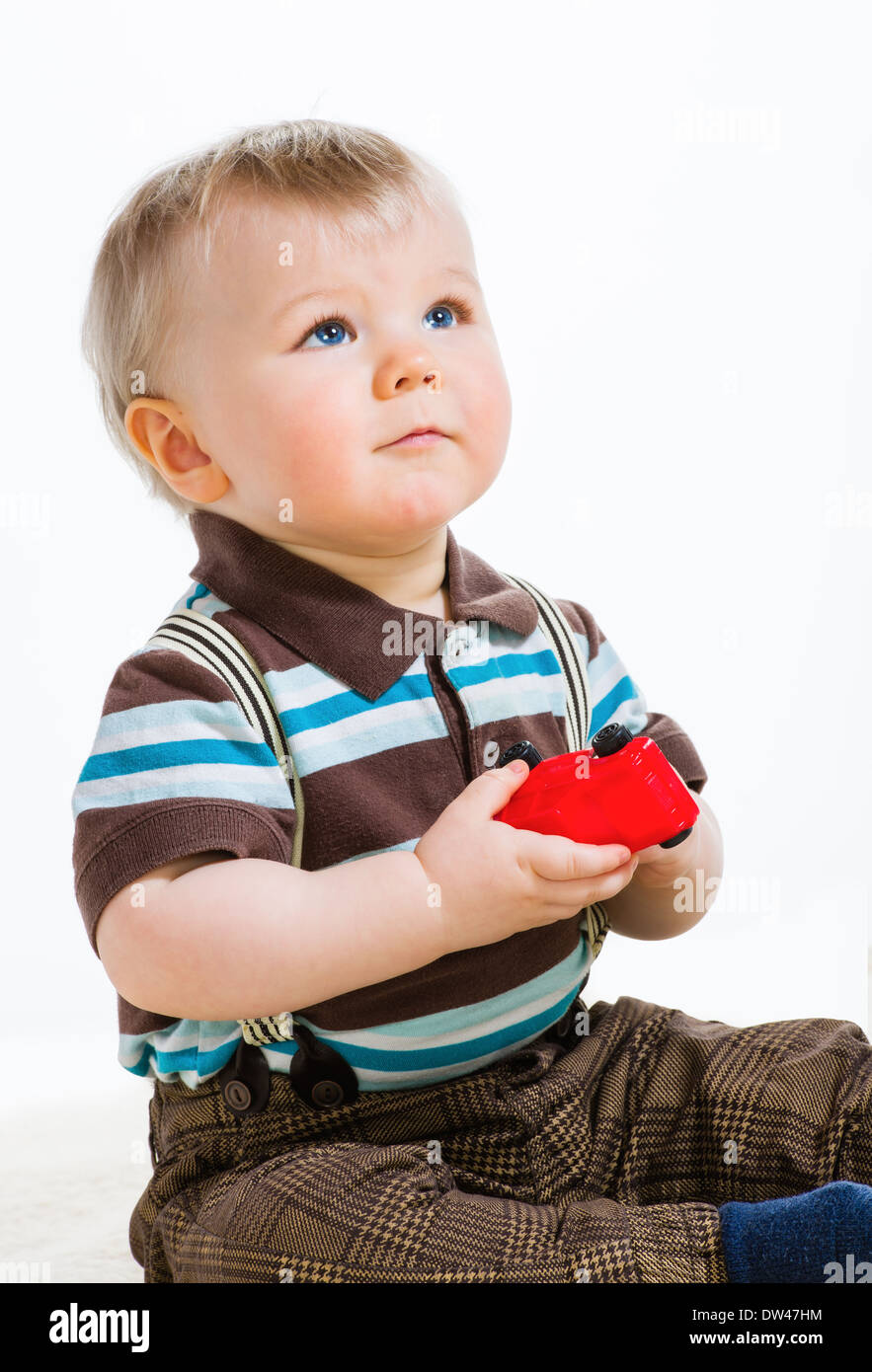 Baby boy, 16 Months old wearing striped shirt and suspenders, white background Stock Photo Alamy