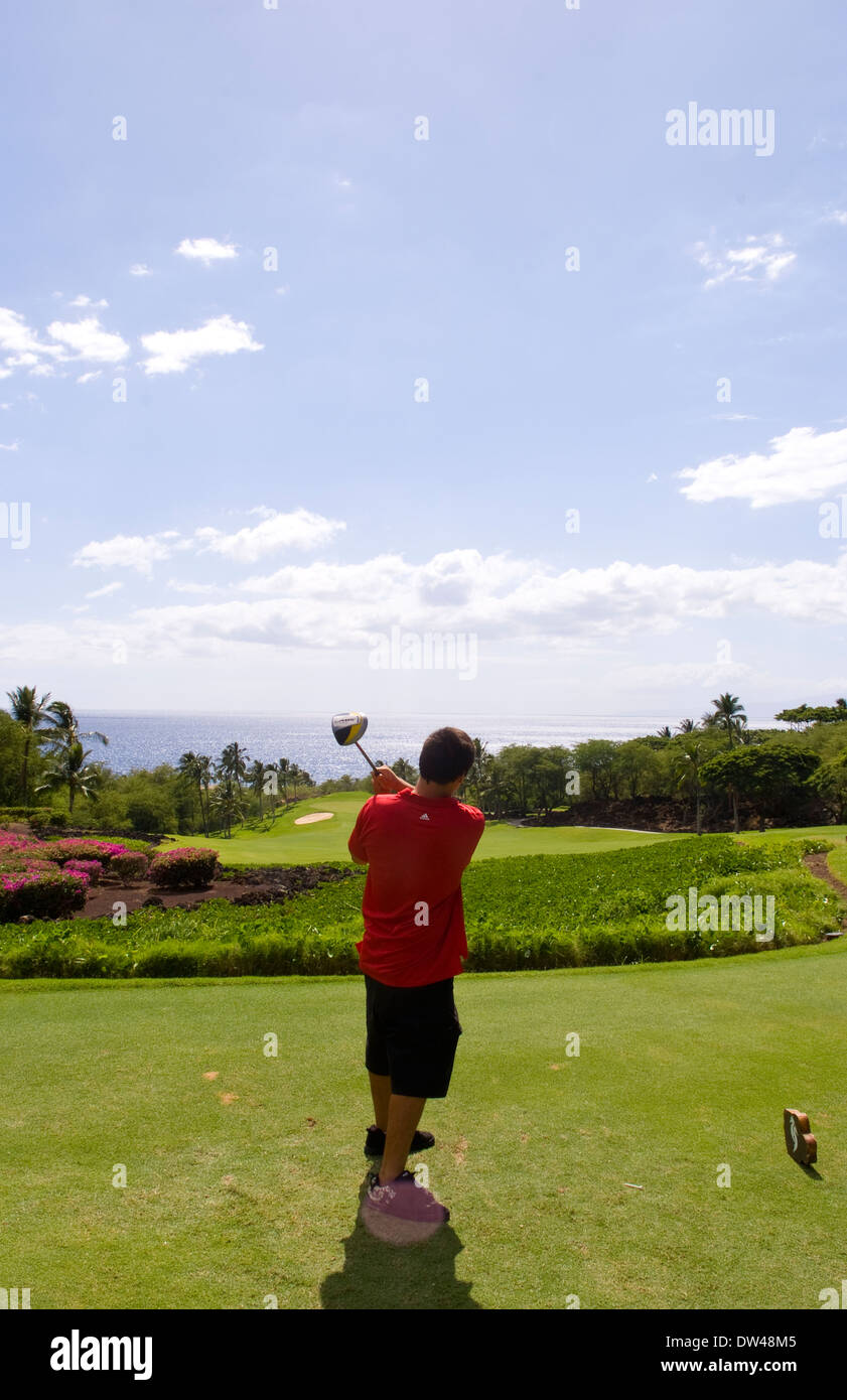Golfer at exclusive beautiful Wailea Emerald Course hole 1 with palm