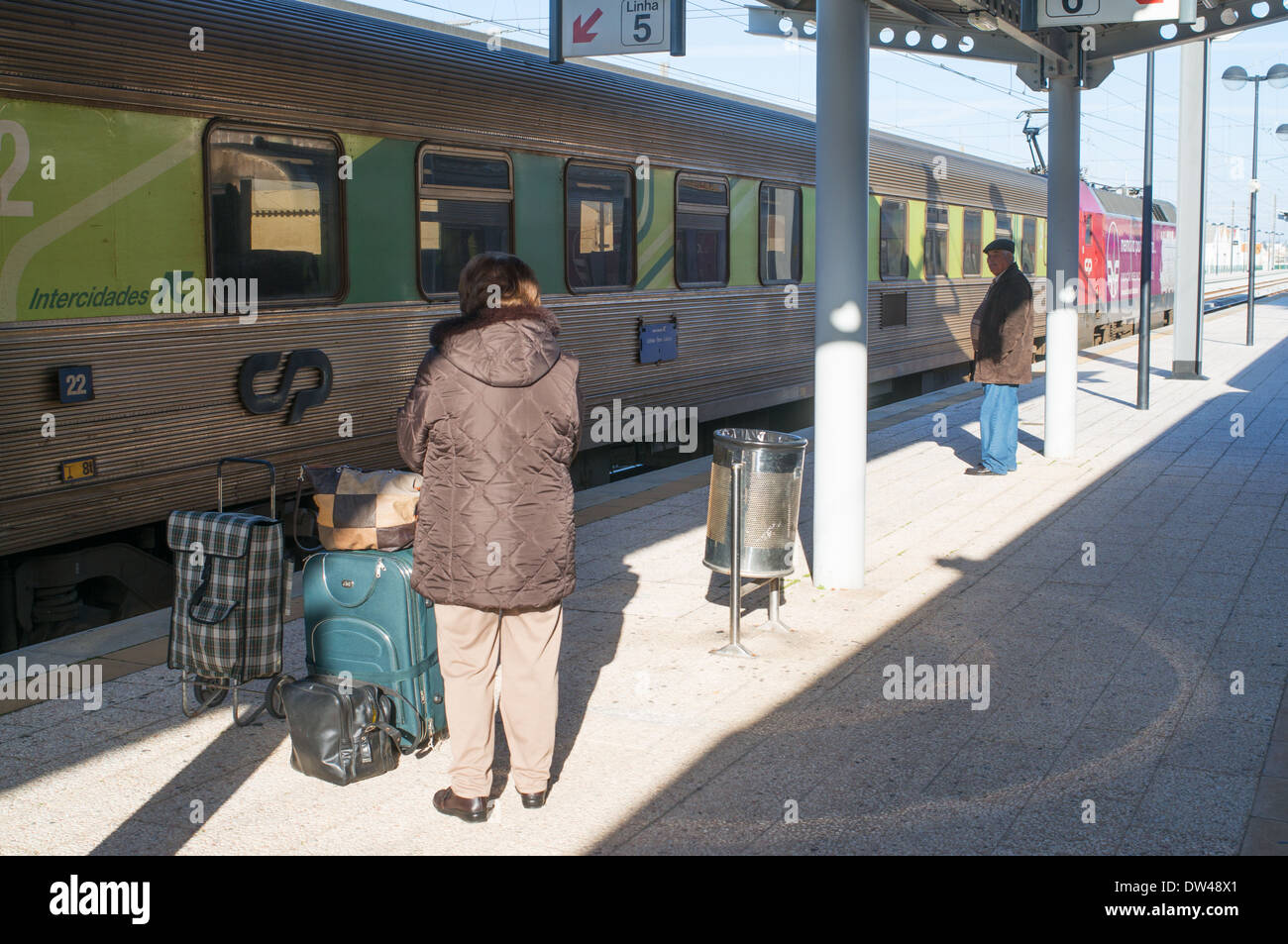 Passengers waiting to board express train at Faro rail station Algarve, Portugal, Europe Stock Photo