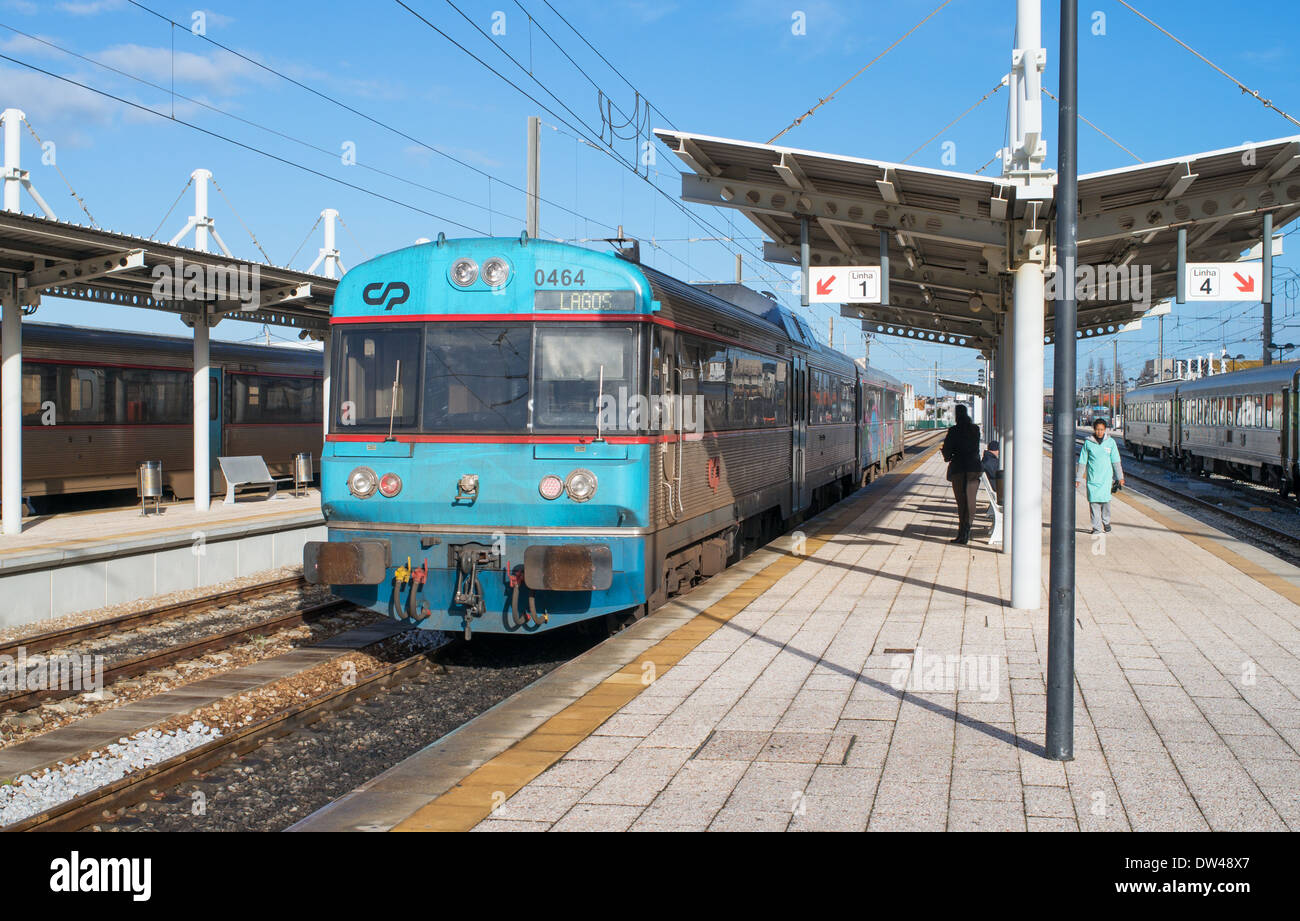 A diesel multiple unit train stands at a platform within Faro rail station, Algarve, Portugal, Europe Stock Photo
