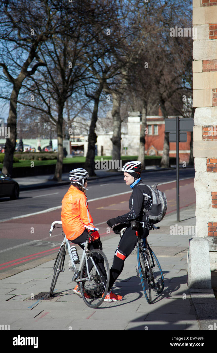 Two Cyclists Chatting on Lambeth Palace Rd in London UK Stock Photo