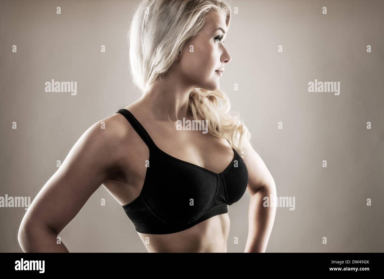 Beautiful blond fitness woman on good shape, desaturated studio shot Stock Photo
