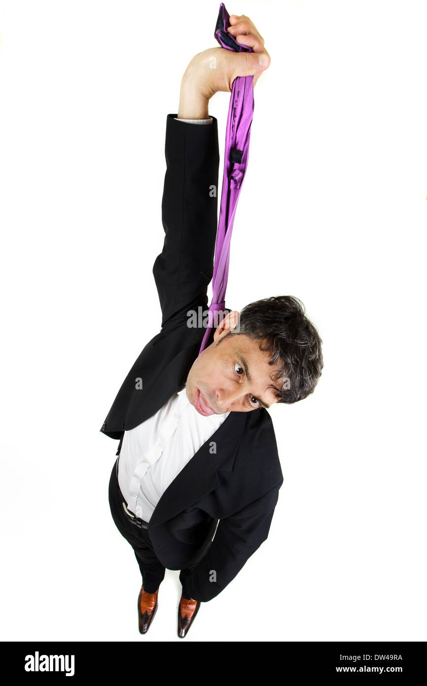 humorous high angle portrait of a businessman committing suicide holding up his tie Stock Photo