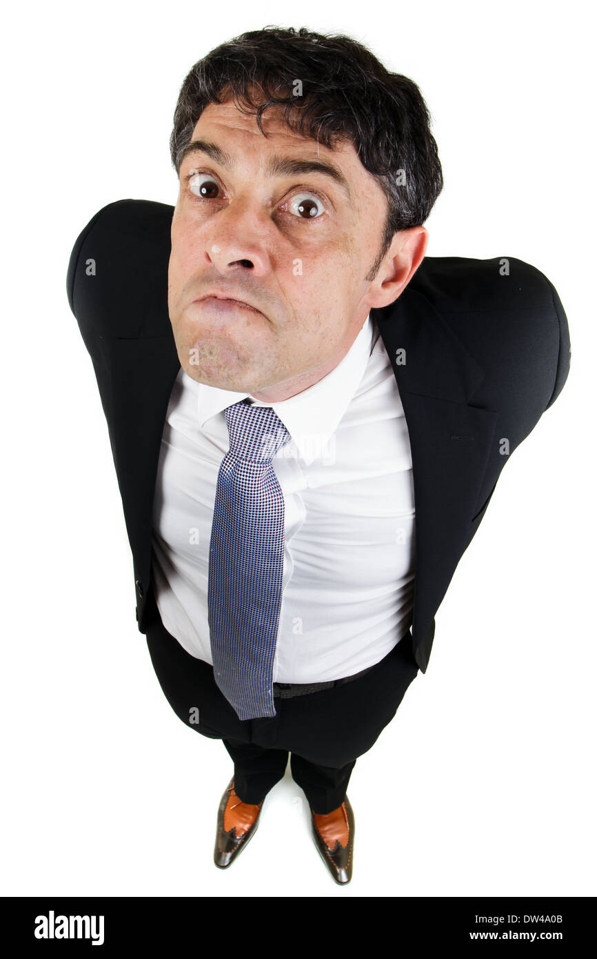 Humorous high angle full length portrait of a businessman with a bad attitude glaring up with a belligerent expression Stock Photo