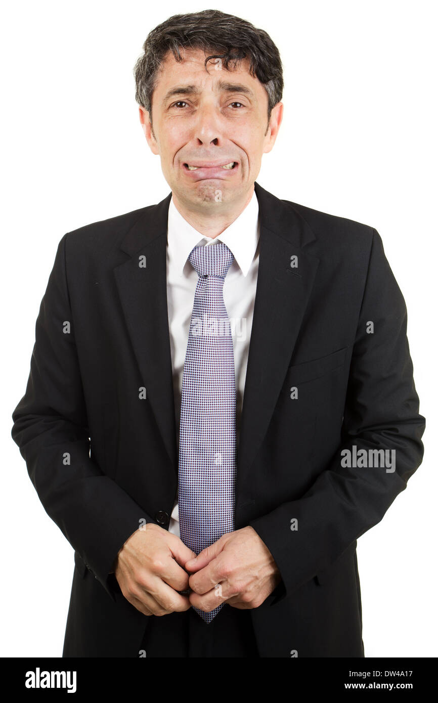 Isolated portrait of a middle-aged businessman standing crying through loss and grief or because of failure Stock Photo