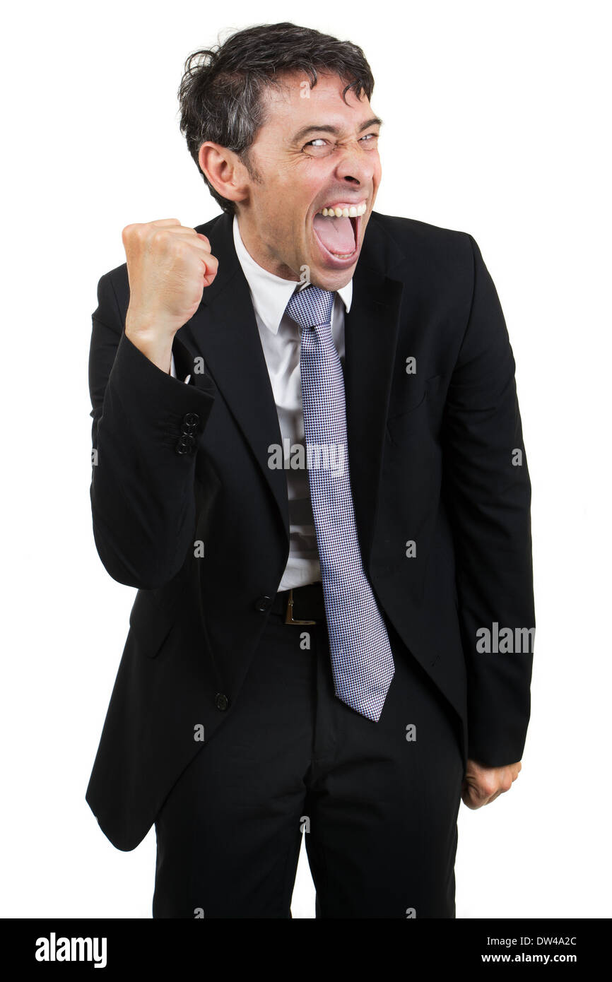 Gleeful businessman celebrating a victory cheering and making a fist of his hand isolated on white Stock Photo