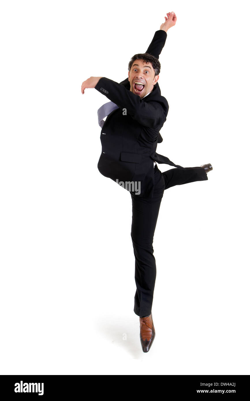 Fun portrait of an excited agile businessman in smart shoes and a suit performing ballet doing a pirouette, isolated on white Stock Photo