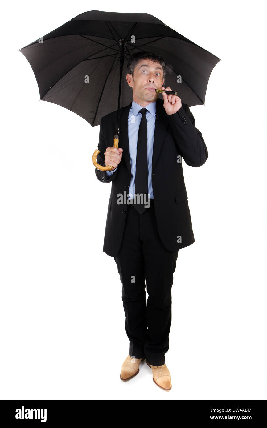 Man holding umbrella and smoking electronic cigarette Stock Photo