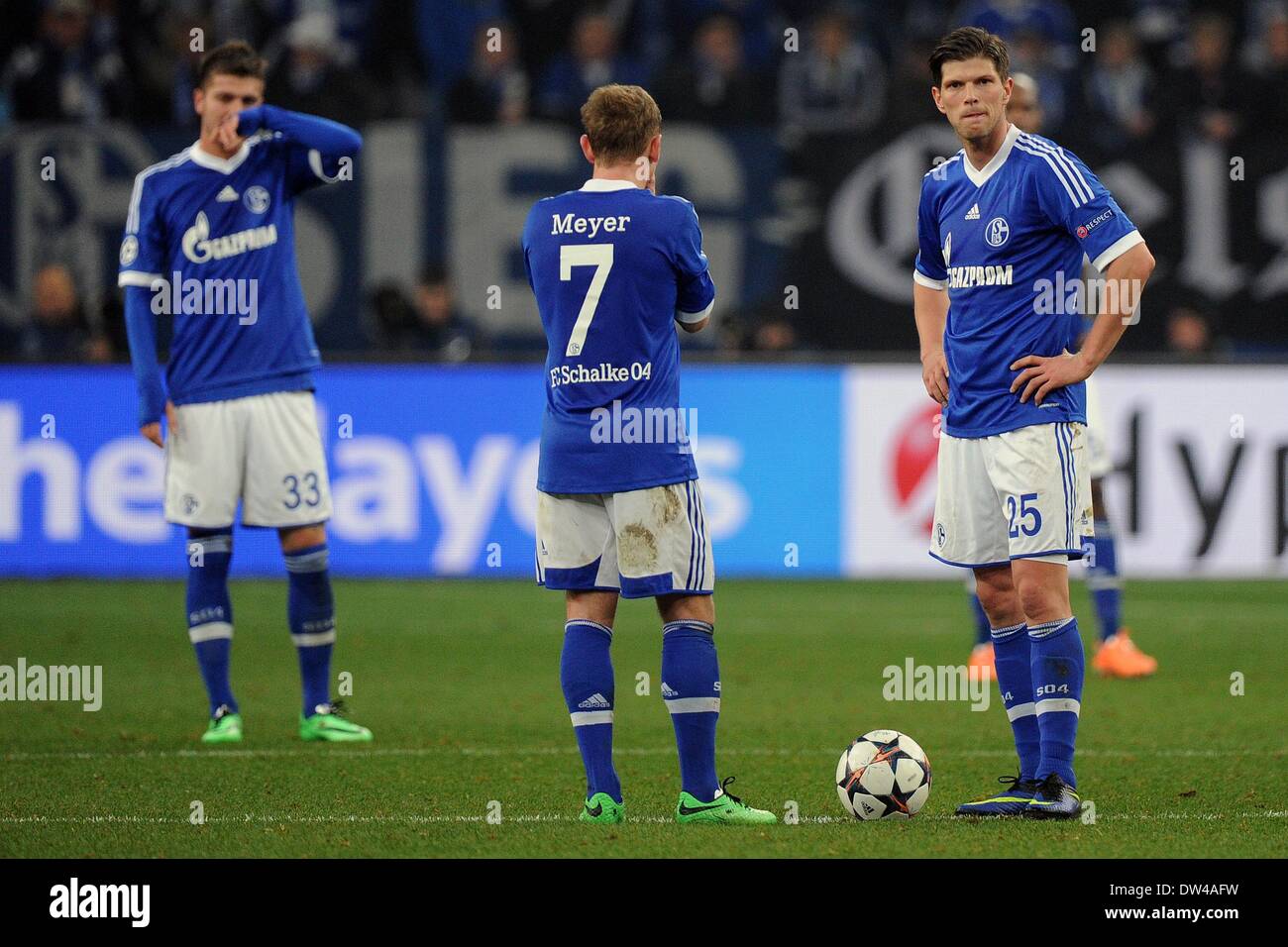 Gelsenkirchen, Germany. 26th Feb, 2014. Schalke's Max Meyer (L) and Klaas-Jan Huntelaar (R) react after the 0-6 goal during the Champions League round of sixteen match between FC Schalke 04 and Real Madrid at Stadium Gelsenkirchen in Gelsenkirchen, Germany, 26 February 2014. Photo: Marius Becker/dpa/Alamy Live News Stock Photo