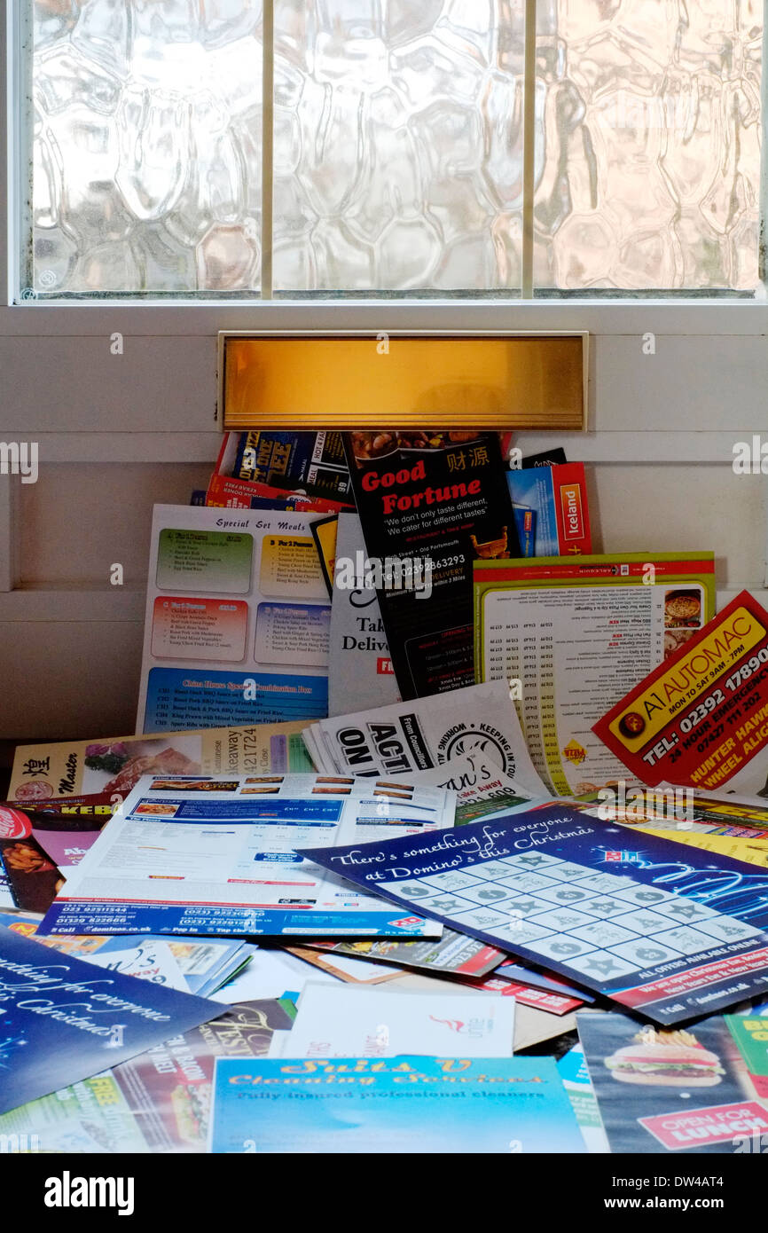 a huge pile of junk mail that has been put through the letter box of a front door Stock Photo