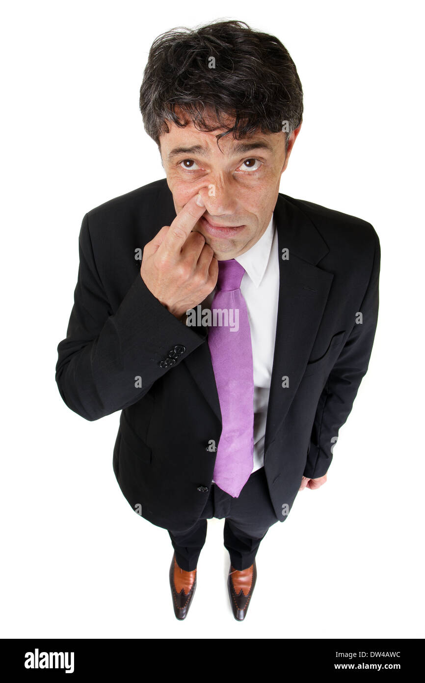 businessman making a rude dismissive gesture raising his finger to tap the side of his nose Stock Photo