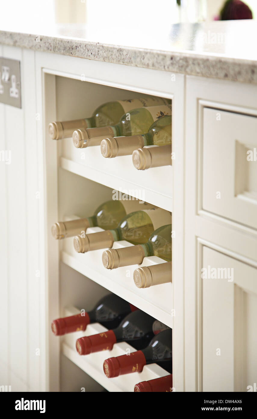 Wine rack with wine bottles in a modern British kitchen, UK. Stock Photo