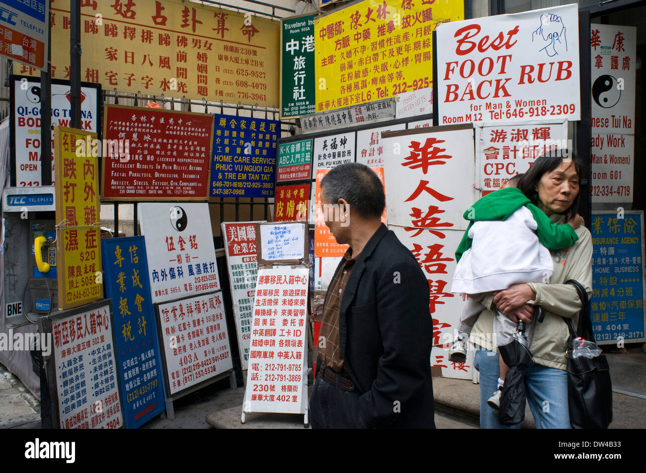 Street corner with Chinese advertising boards, Chinatown, Lower East Side, New York City, USA. The Chinatown neighborhood Stock Photo