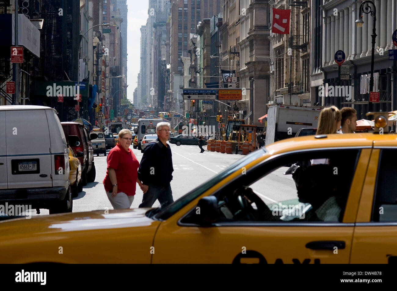 YELLOW TAXI CAB BROADWAY STREET SOHO MANHATTAN NEW YORK CITY USA. A taxi passes Soho up to Broadway Street. This neighborhood Stock Photo