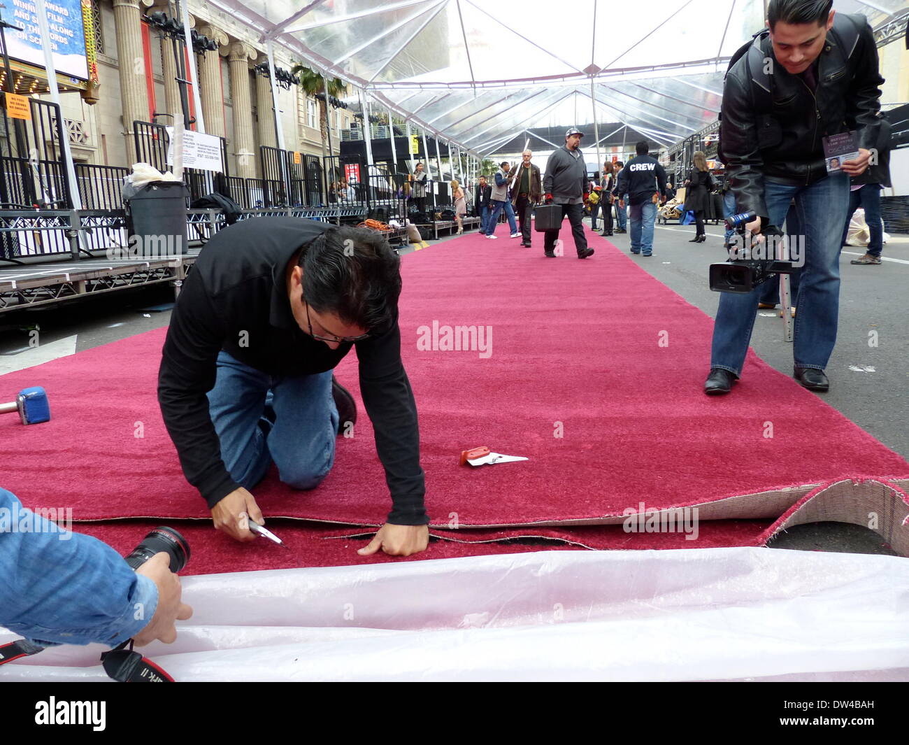 Employees from "American Turf & Carpet" install the red carpet for the
