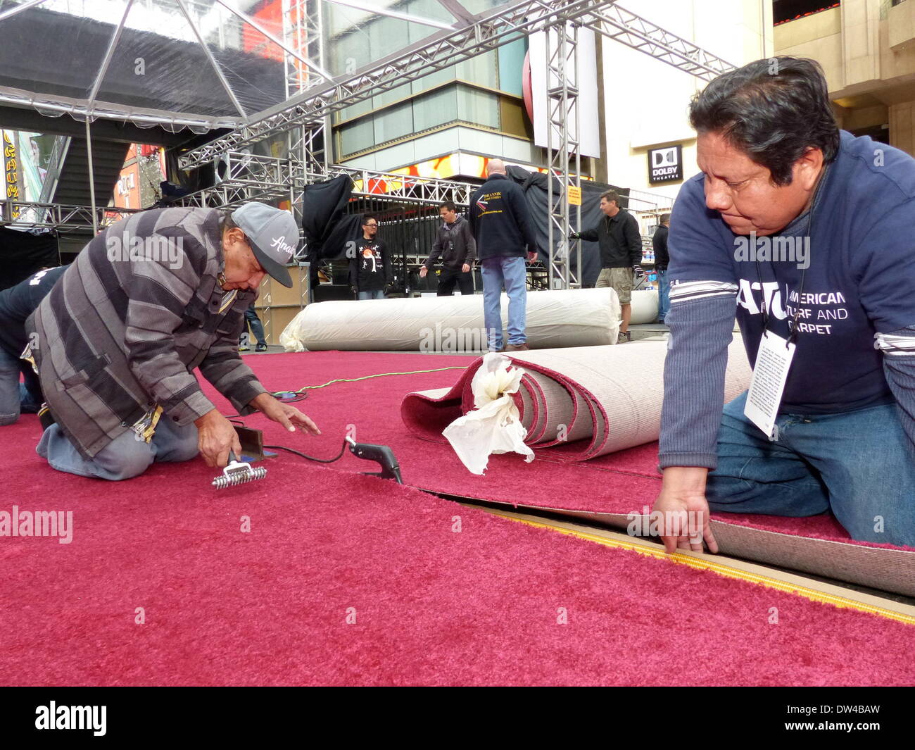 Employees from "American Turf & Carpet" install the red carpet for the