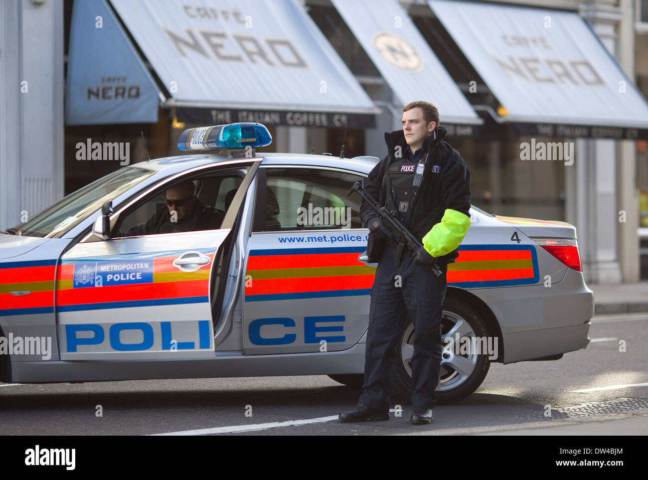 Armed City of London Police convoy escorts a prison van as it arrives at the Old Bailey in London. Stock Photo