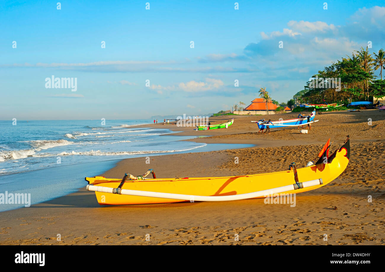 Balinese fisherman village at sunrise. Traditional Balinese fisherman boat on foreground Stock Photo