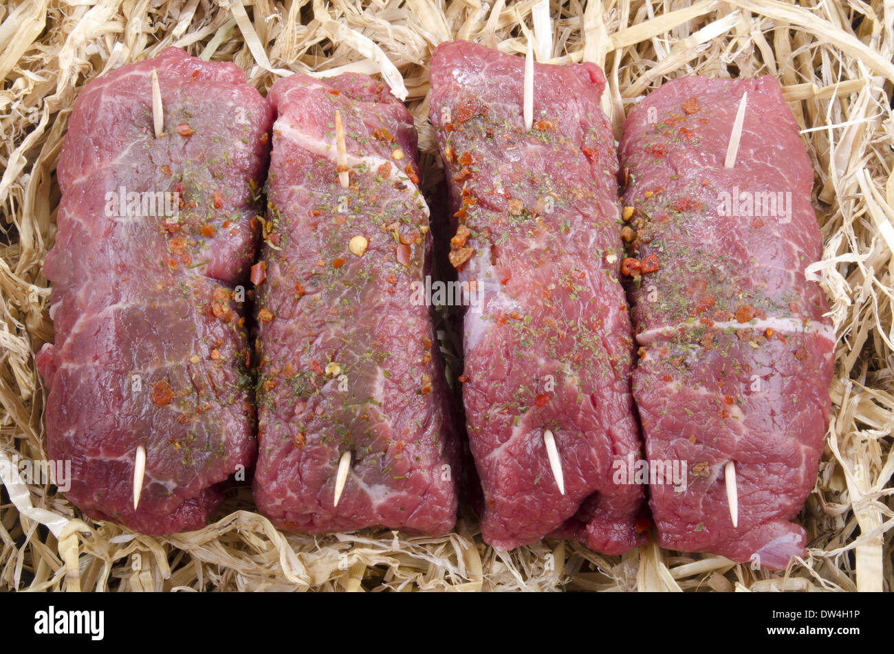 rolled braising steak in a straw bed Stock Photo Alamy