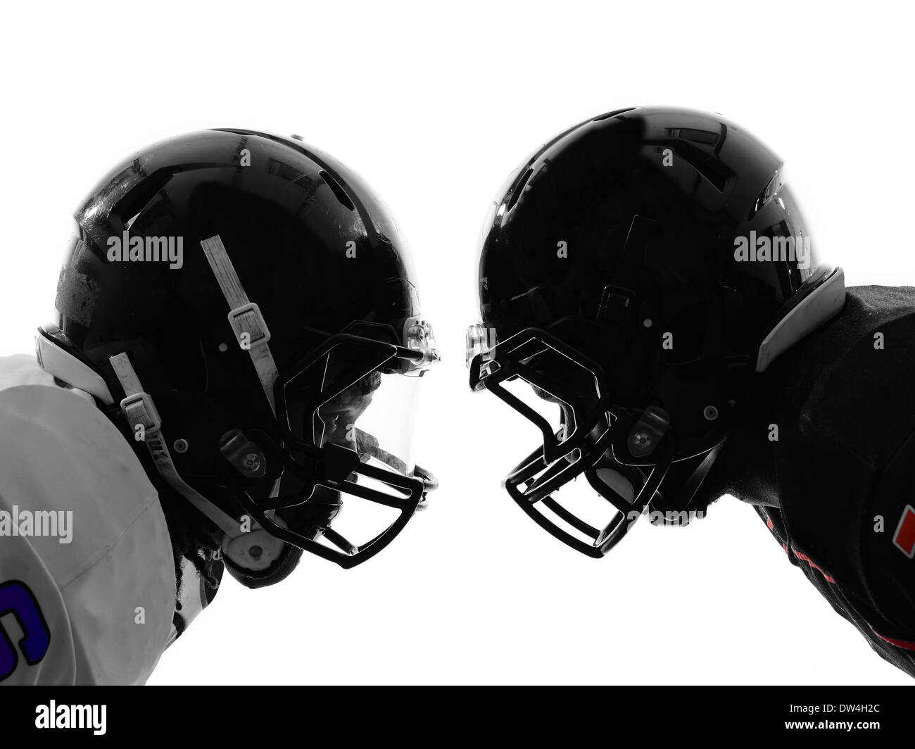 two american football players face to face in silhouette shadow on white background Stock Photo