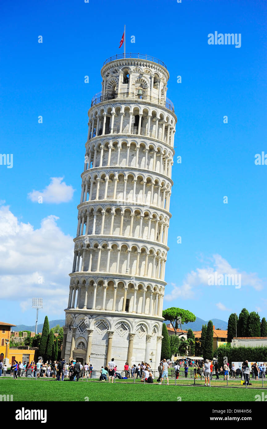 Tourists on Square of Miracles visiting Leaning Tower in Pisa, Italy. Stock Photo