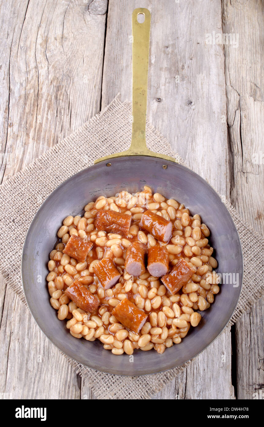 warm baked bean and sausage in a rustic pan Stock Photo - Alamy