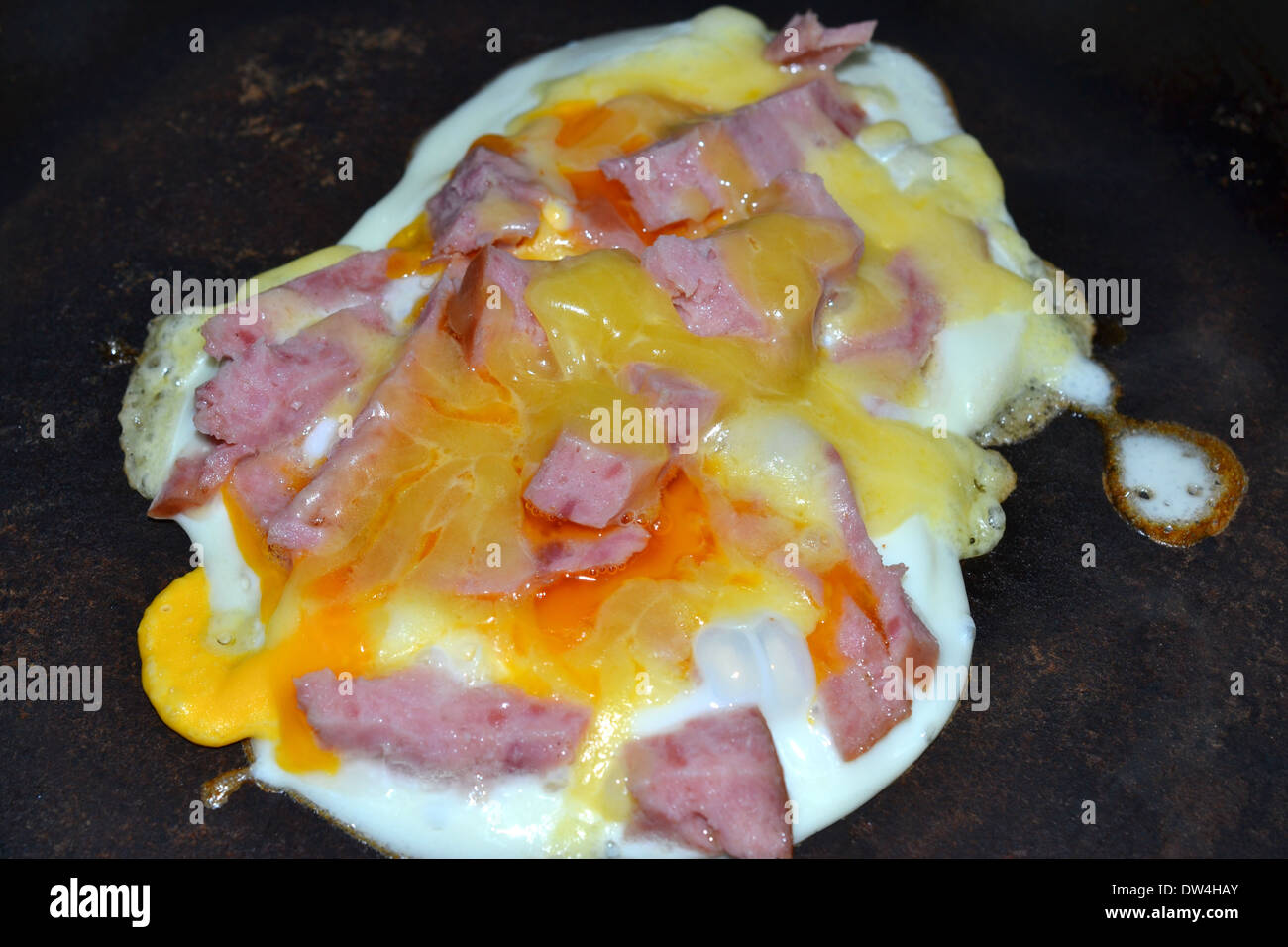 egg ham and cheese cooking in frying pan Stock Photo Alamy