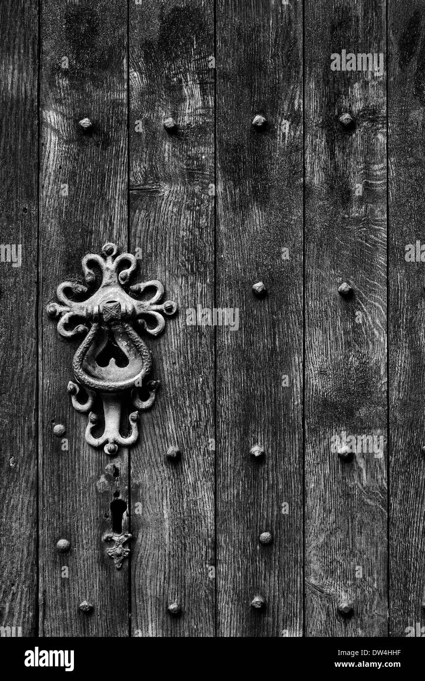 Old Oak church door and ironwork handle detail. England. Black and white Stock Photo