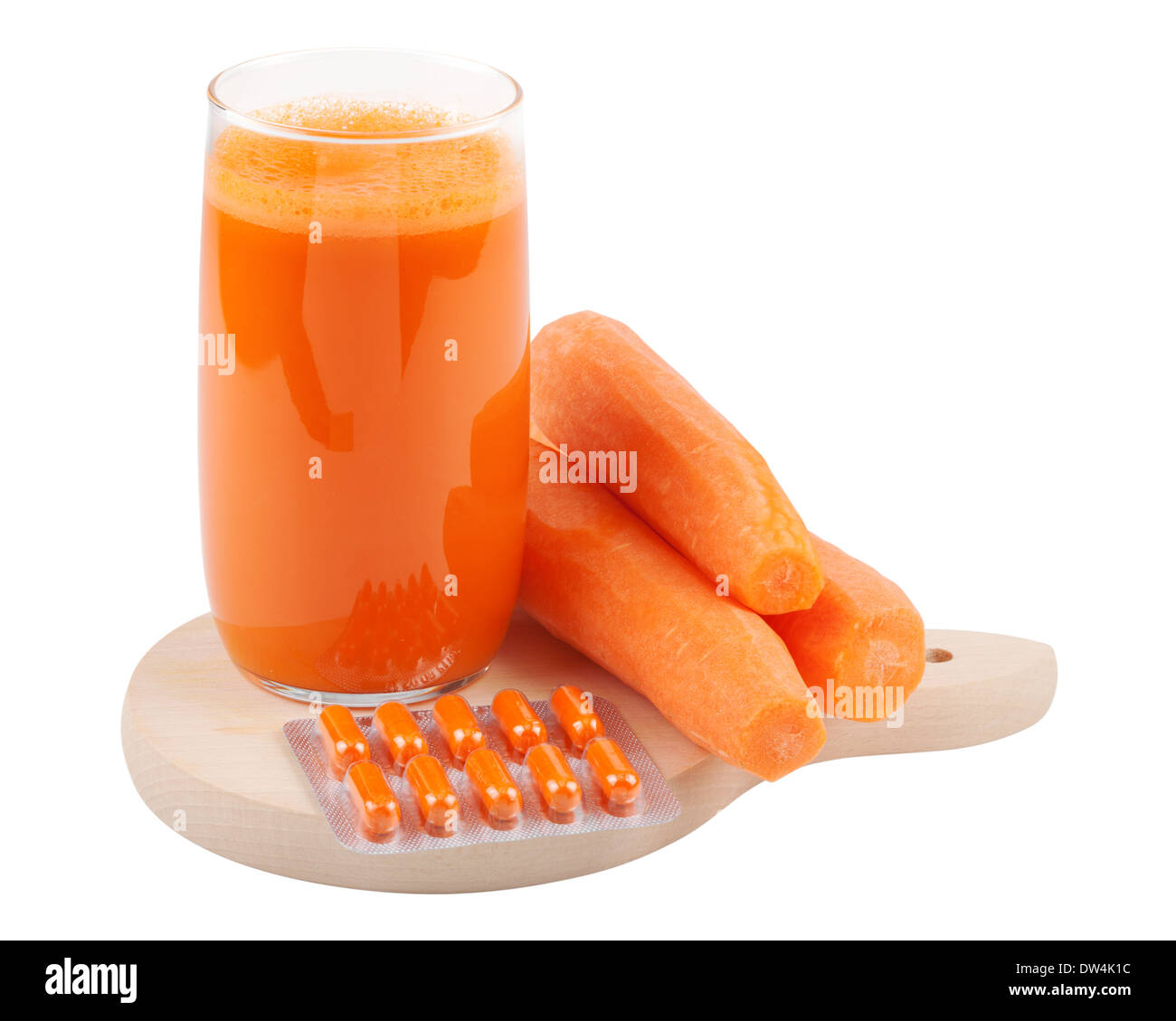 carrot juice, fresh carrots and beta Carotene capsules on cutting board Stock Photo