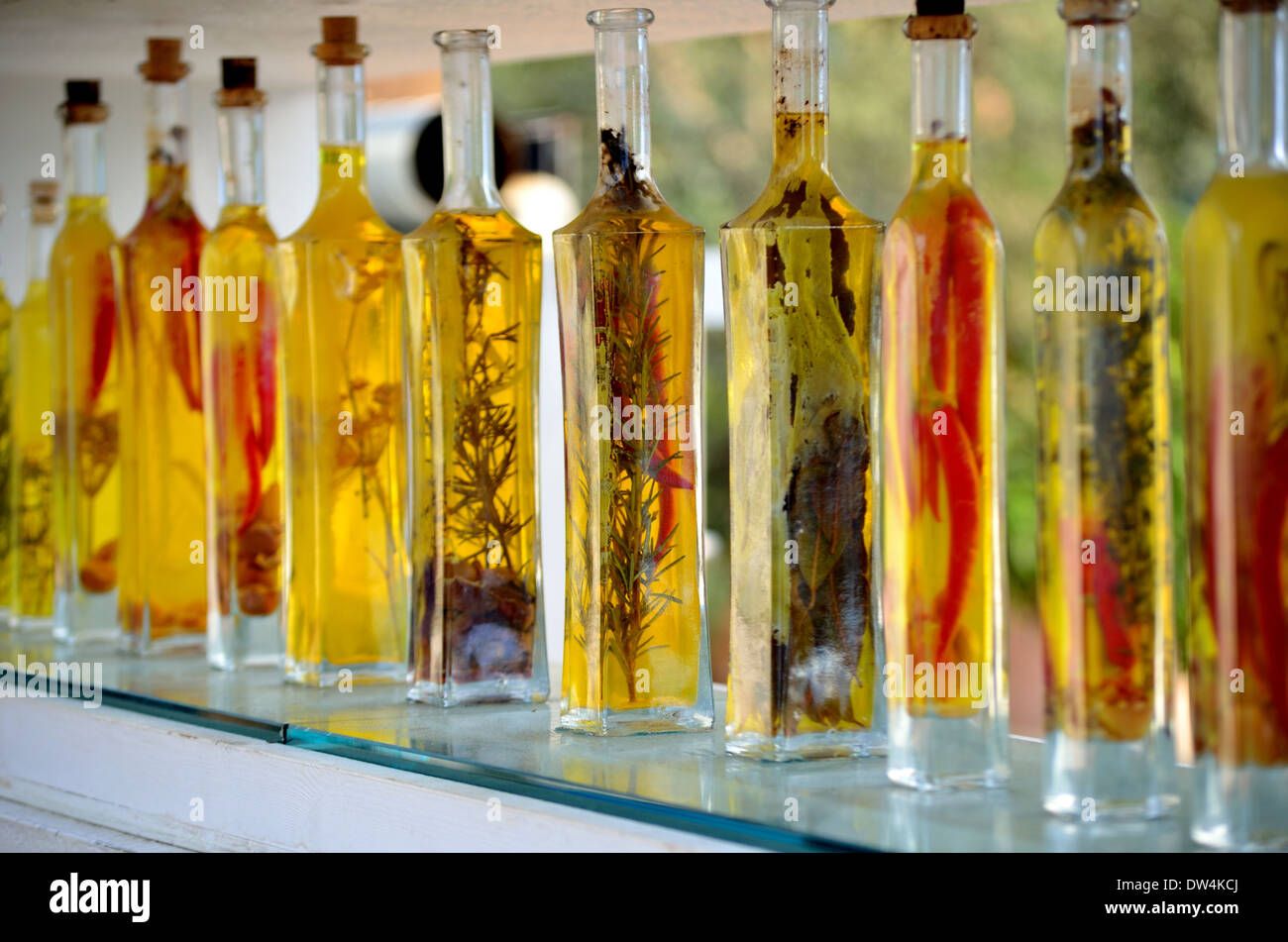 Decorative Bottles Of Olive Oil On A Glass Shelf Stock Photo
