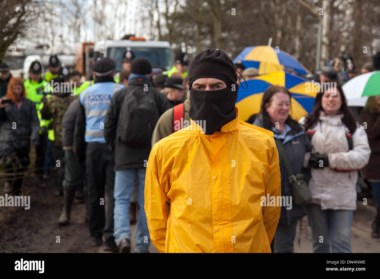 Manchester, Barton Moss, UK. 27th February, 2014. Masked protester delaying lorries as protests continue at IGAS Drilling Site.  Greater Manchester Policing operation at Barton Moss Drilling Site as protesters seek to delay and obstruct delivery vehicles and drilling equipment en-route to the controversial gas exploration site. Fracking protestors have set up a camp at Barton Moss Road, Eccles a potential methane-gas extraction site in Salford, Greater Manchester. Stock Photo