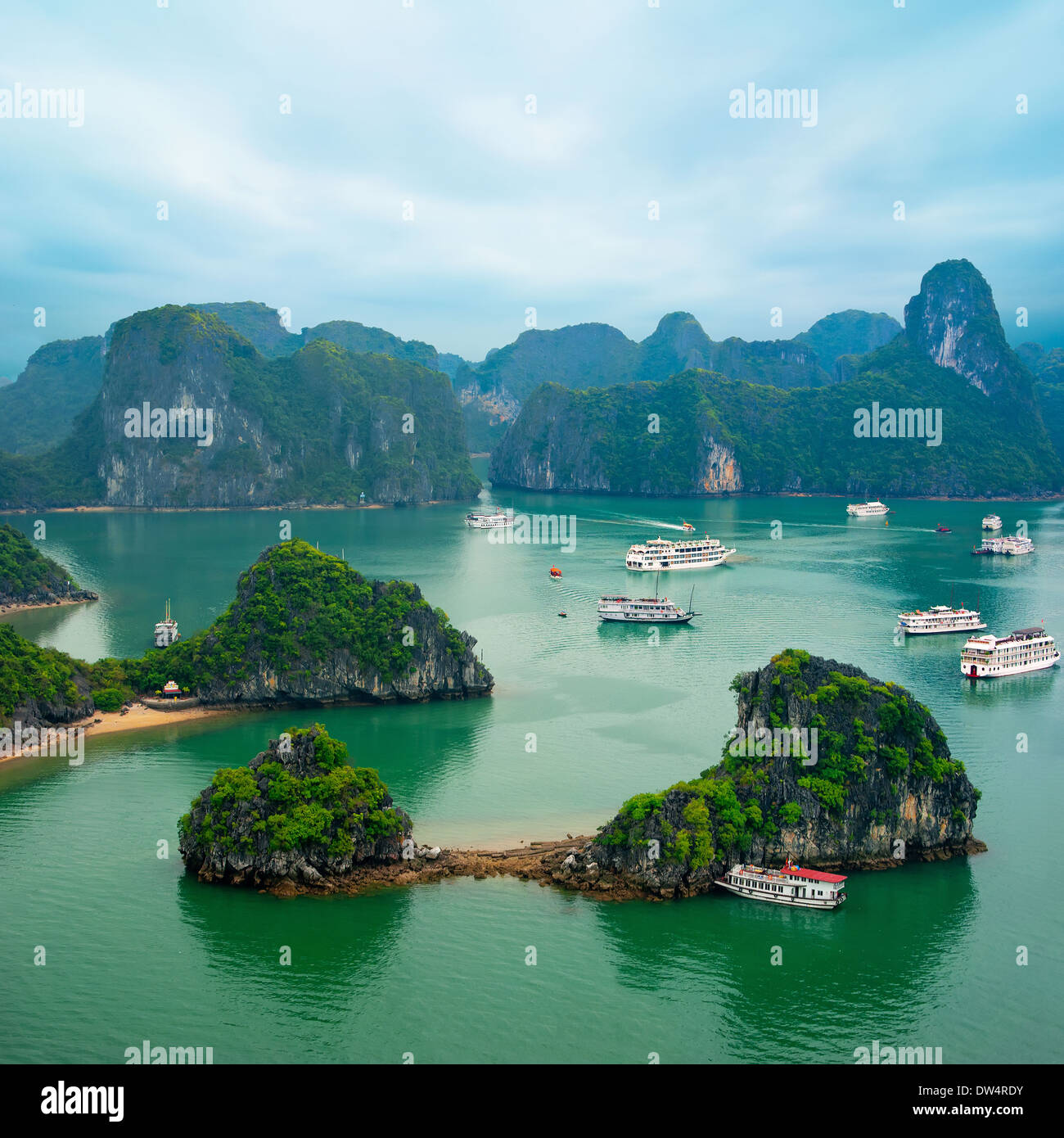 Tourist junks floating among limestone rocks at early morning in Ha Long Bay South China Sea Vietnam Southeast Asia Two images Stock Photo