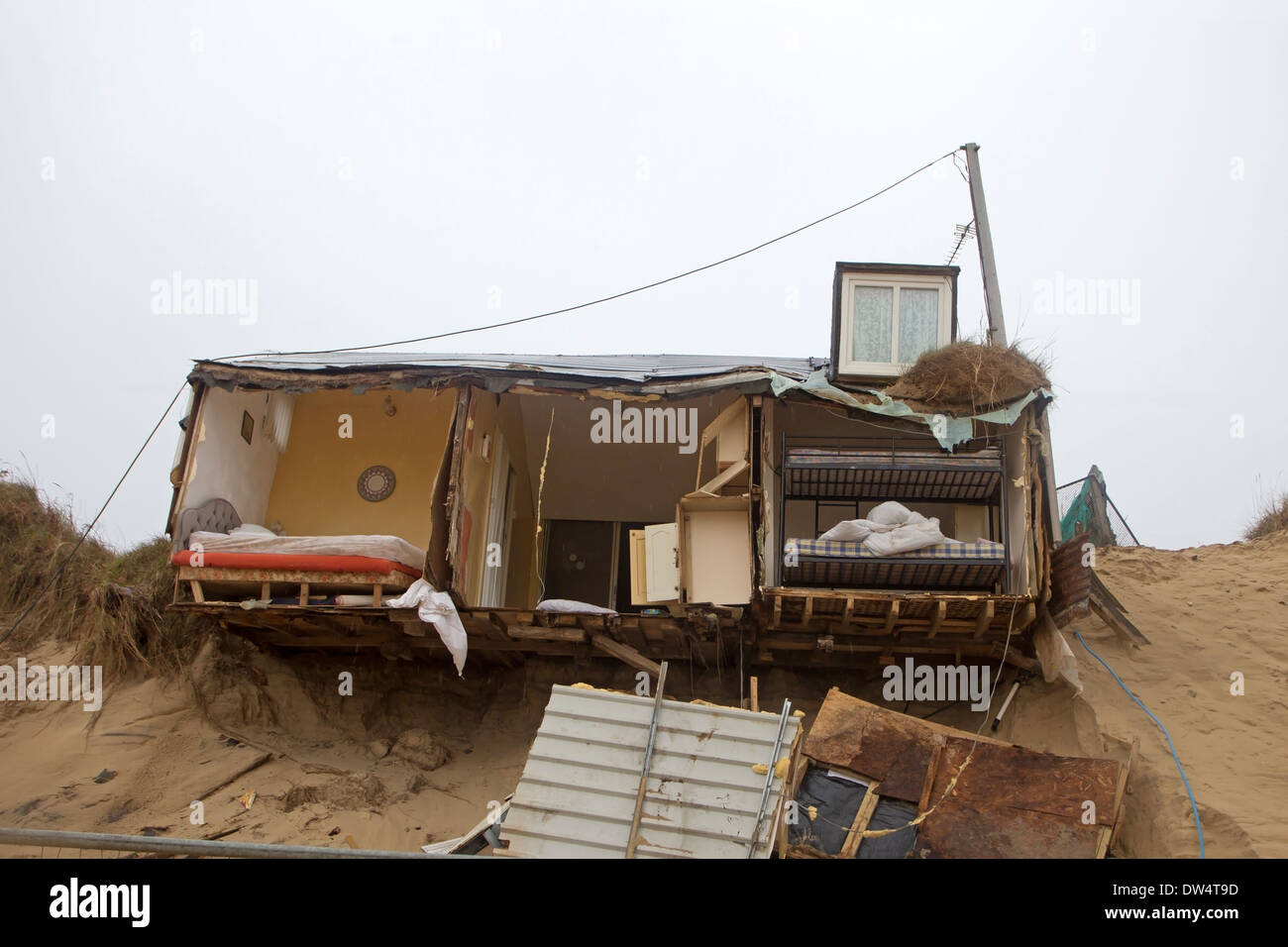 Eroded cliffs and damaged chalets following tidal surges of December 2013, Hemsby, Norfolk UK Stock Photo