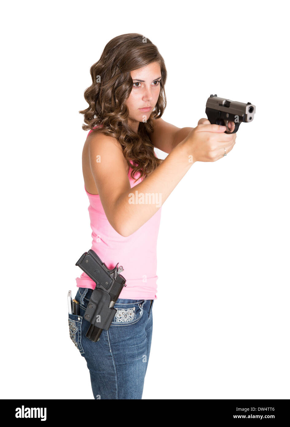 Young girl pointing pistol with another gun holstered on hip Stock Photo