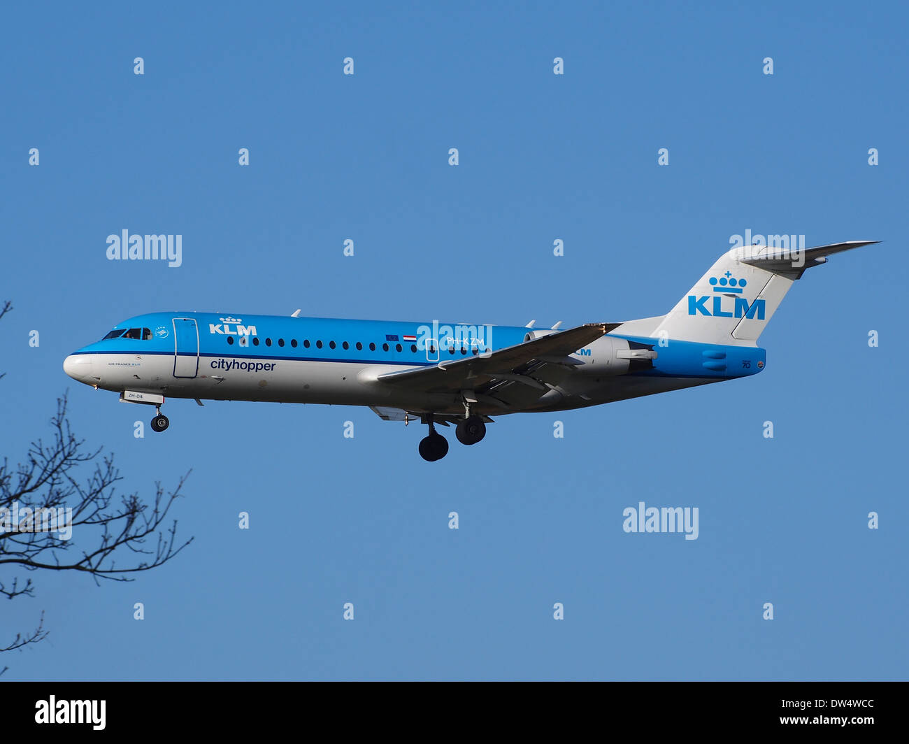 The KLM Cityhopper Fokker 70/100 PH-KZM is a regional airliner used for short-haul flights. This aircraft is known for its efficiency and comfort in serving European routes, seen landing at Schiphol Airport in 2014. Stock Photo