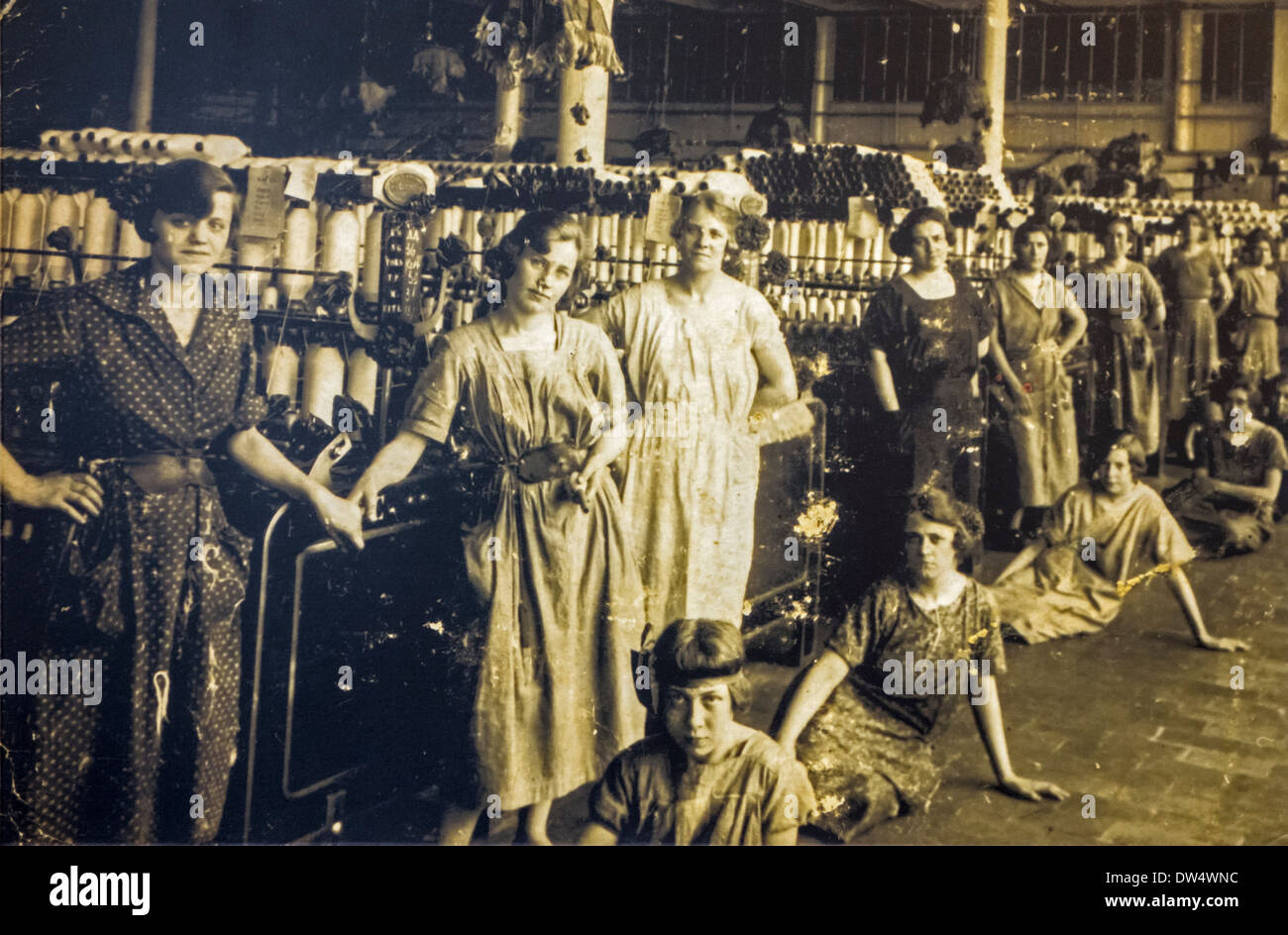 Old archival photograph showing female workers posing in spinning mill in the early twentieth century, Ghent, Belgium Stock Photo
