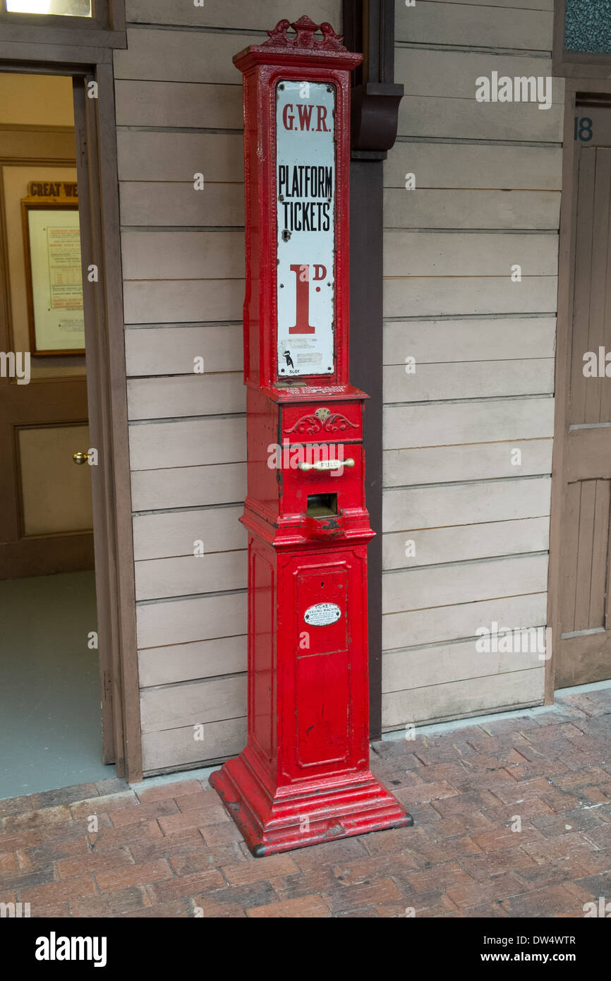 A red GWR 1d station platform ticket vending machine exhibit. On display at the Steam Museum, Swindon, Wiltshire, UK Stock Photo