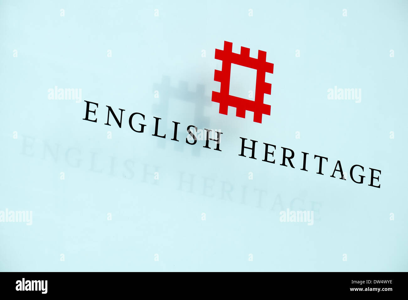 The English Heritage logo & text on a glass panel with shadow projected behind at their offices in Swindon, Wiltshire, UK Stock Photo