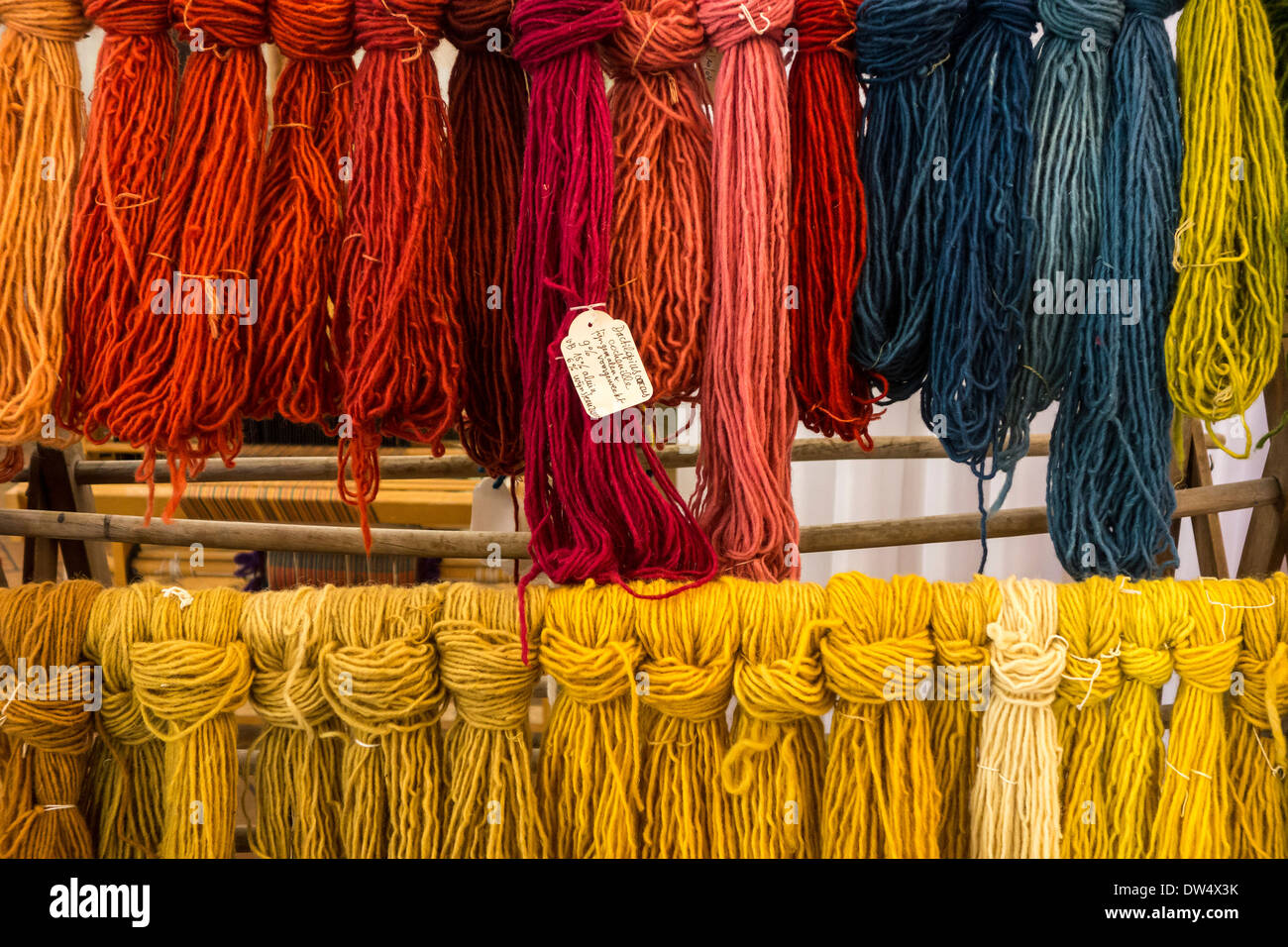 Colourful dyed strands of wool for weaving clothes in spinning mill Stock Photo