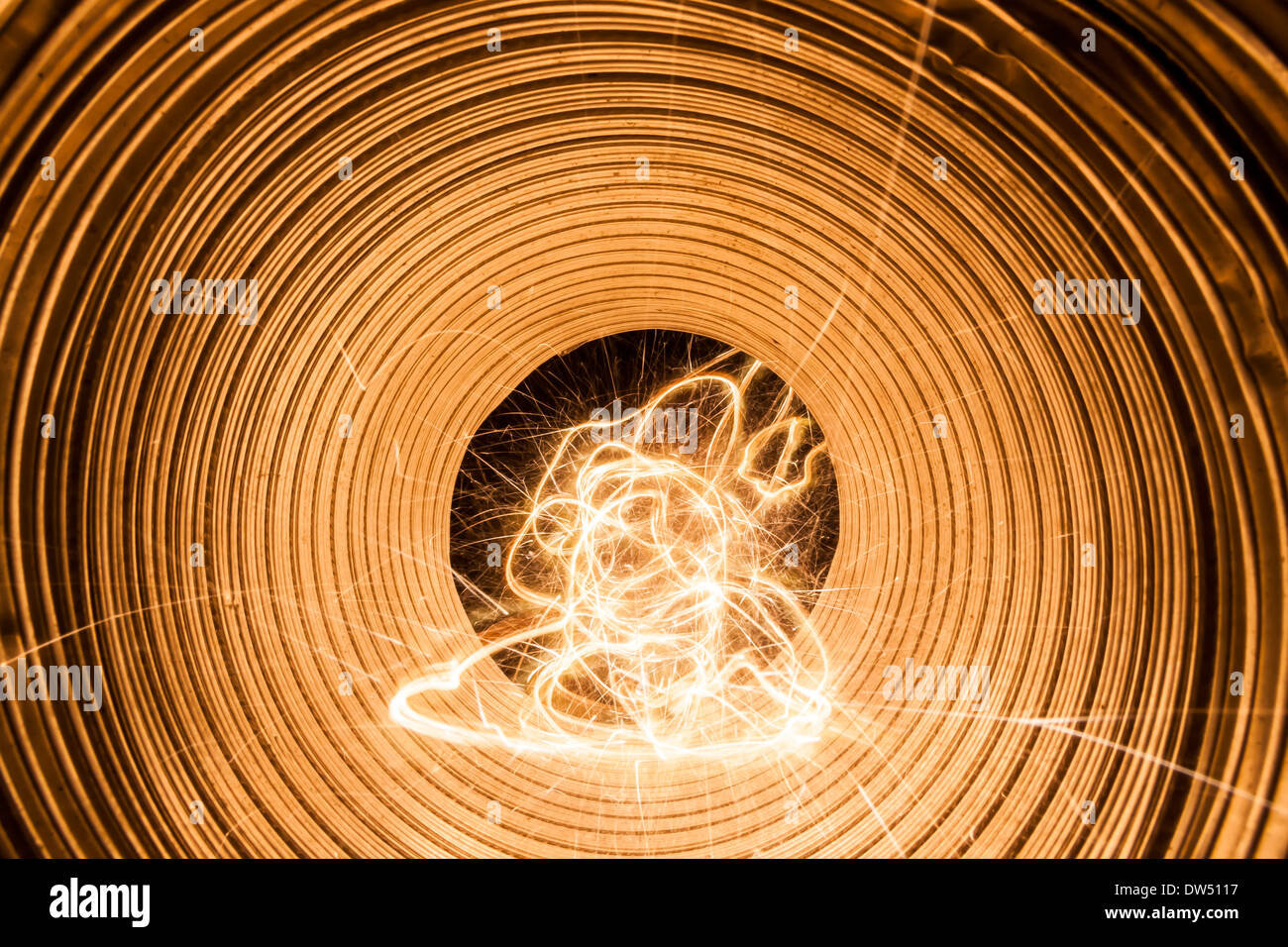 Random electric light trails in a pipe that shines in light Stock Photo