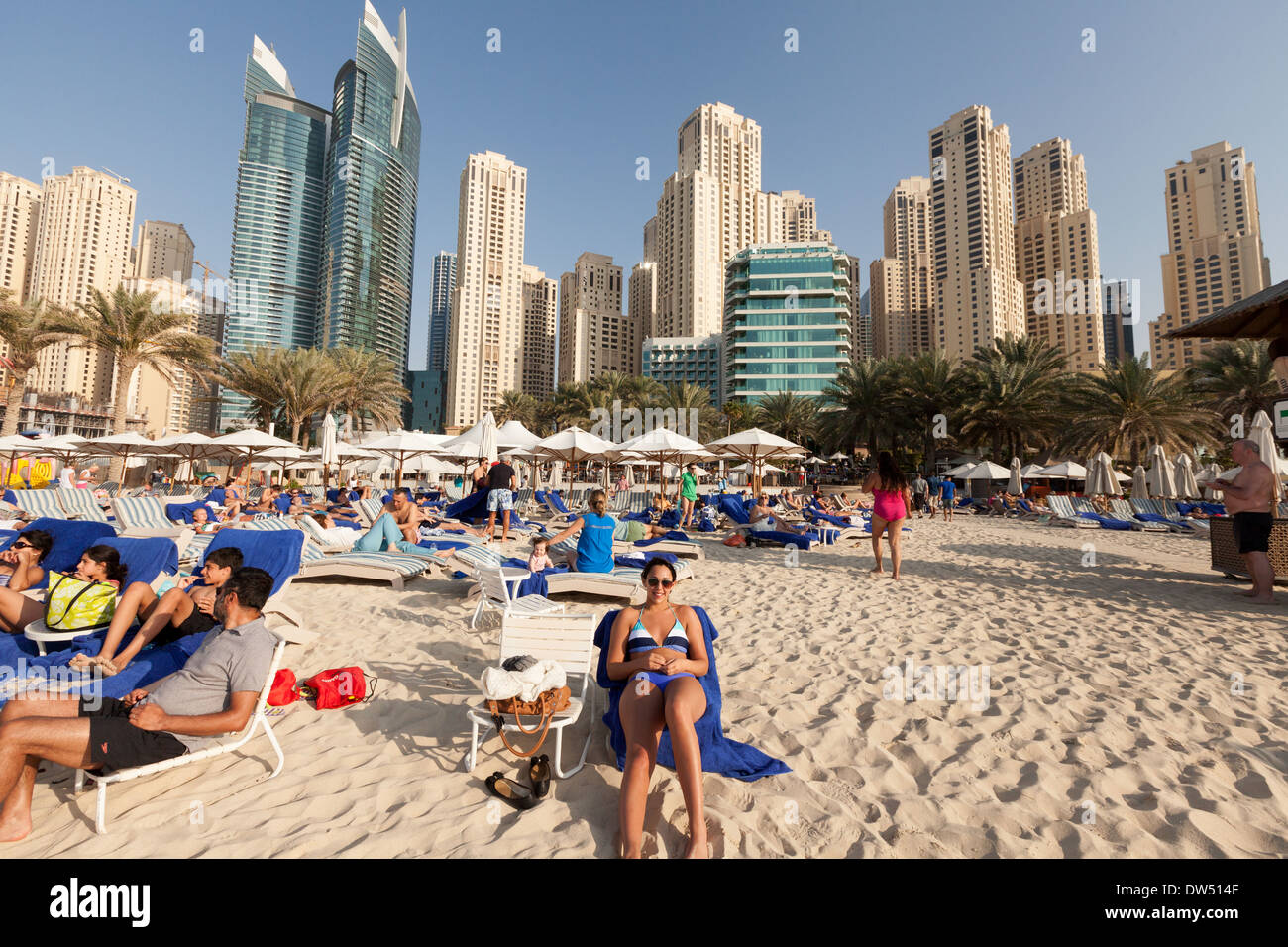 Dubai Beach; 5 star Hilton Hotel and beach with guests on holiday, Jumeirah Beach Resort, Dubai, United Arab Emirates, UAE, Middle east Stock Photo